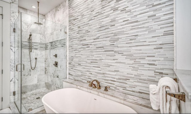 bathroom with separate shower and tub and tile walls