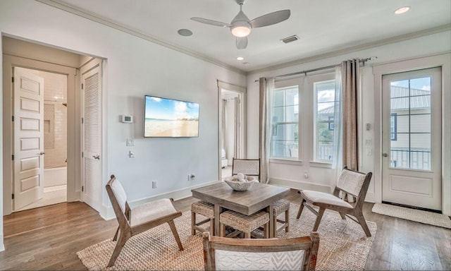 sitting room featuring hardwood / wood-style floors, ceiling fan, and crown molding