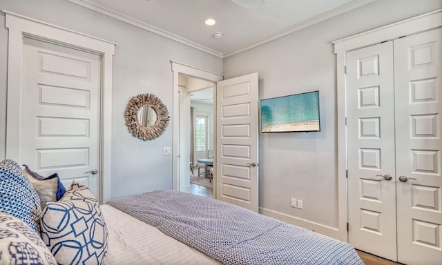 bedroom with a closet and crown molding