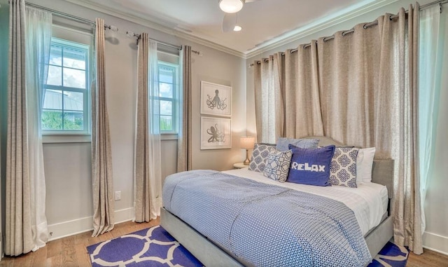 bedroom featuring hardwood / wood-style flooring and crown molding