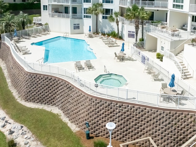 view of pool featuring a hot tub and a patio area