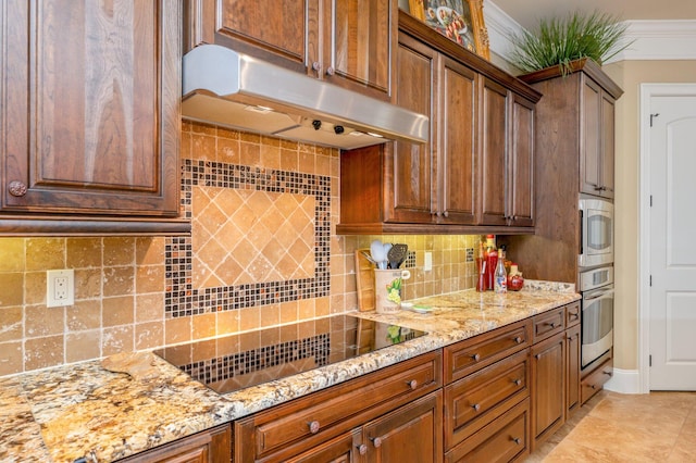 kitchen featuring ornamental molding, stainless steel appliances, light tile floors, light stone counters, and tasteful backsplash