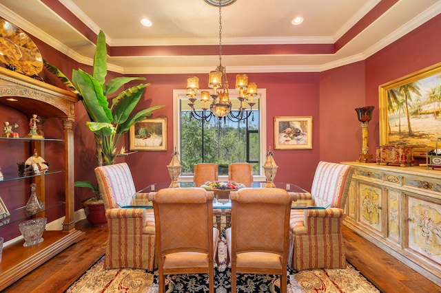 dining space featuring hardwood / wood-style floors, a notable chandelier, and crown molding