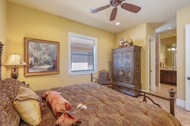 bedroom featuring ceiling fan, light tile flooring, and ensuite bath