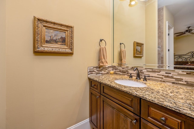 bathroom with backsplash, oversized vanity, and ceiling fan