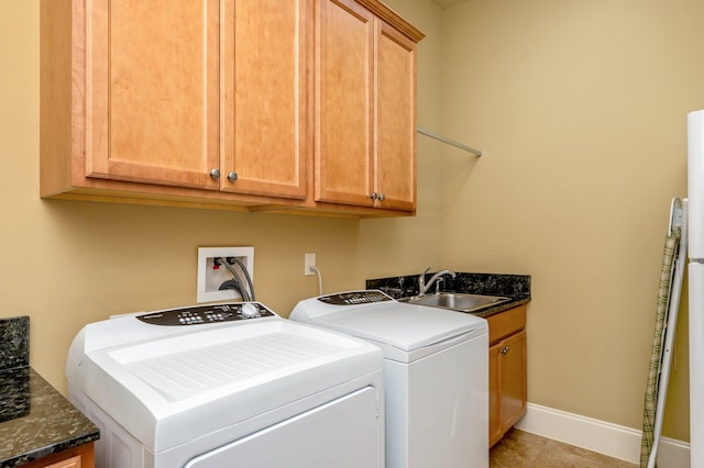 washroom featuring light tile flooring, washer and dryer, hookup for a washing machine, sink, and cabinets