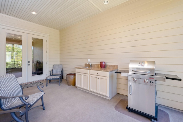 view of terrace with french doors, a grill, and sink