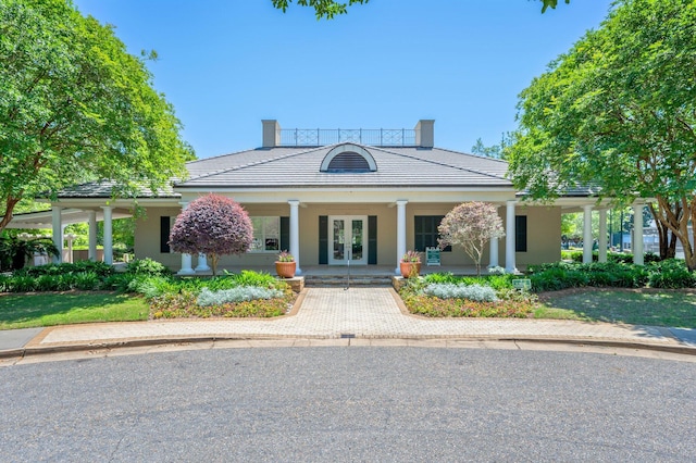 view of front of property with french doors and covered porch