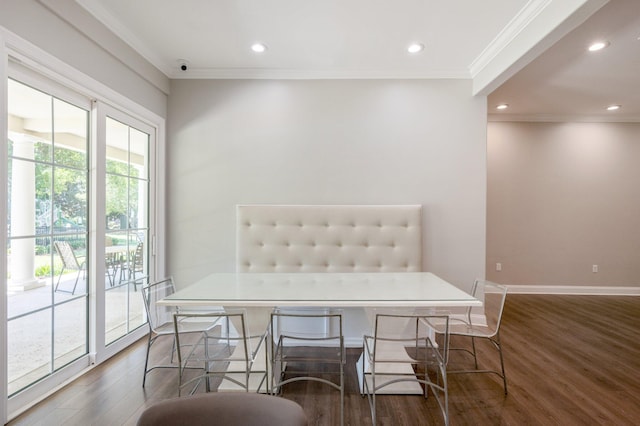 dining area featuring a wealth of natural light, ornamental molding, and dark wood-type flooring