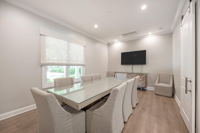 dining area featuring ornamental molding and wood-type flooring