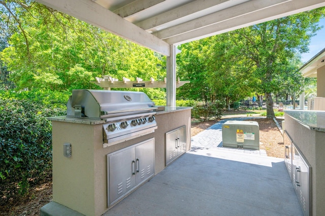 view of patio / terrace with exterior kitchen and a grill