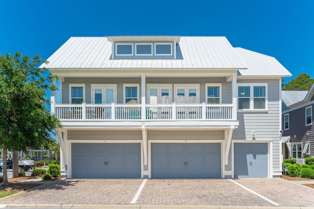 view of front of property with a garage and a balcony