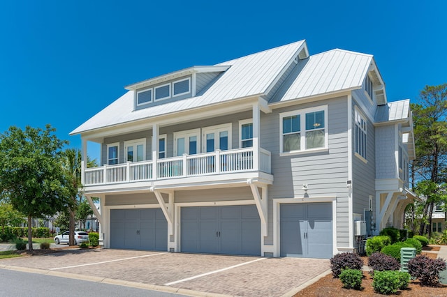 view of front of property with a garage and a balcony