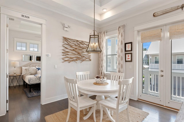 dining room featuring dark hardwood / wood-style flooring and a tray ceiling