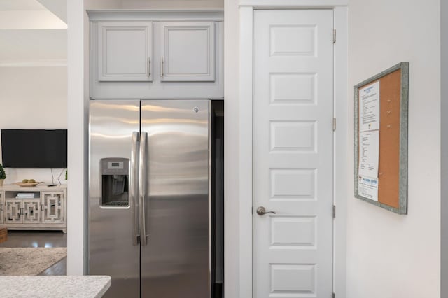 kitchen featuring hardwood / wood-style floors and stainless steel fridge