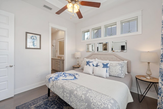 bedroom featuring dark hardwood / wood-style flooring, ceiling fan, and ensuite bath