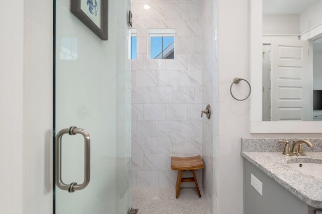 bathroom featuring vanity with extensive cabinet space and an enclosed shower