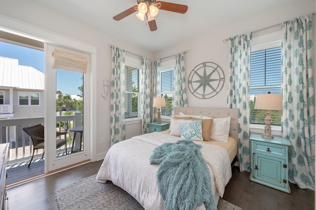 bedroom with dark hardwood / wood-style flooring, access to exterior, and multiple windows