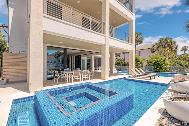 view of pool featuring an in ground hot tub and a patio