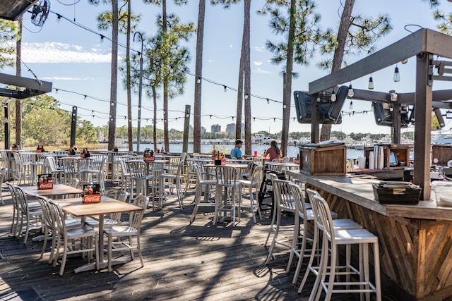 exterior space with a water view and an outdoor bar