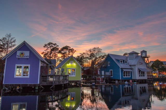 back house at dusk featuring a water view