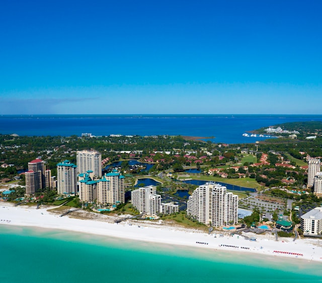 birds eye view of property featuring a beach view and a water view