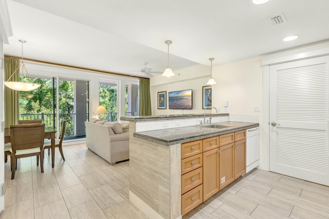 kitchen featuring pendant lighting, white dishwasher, sink, ceiling fan, and kitchen peninsula