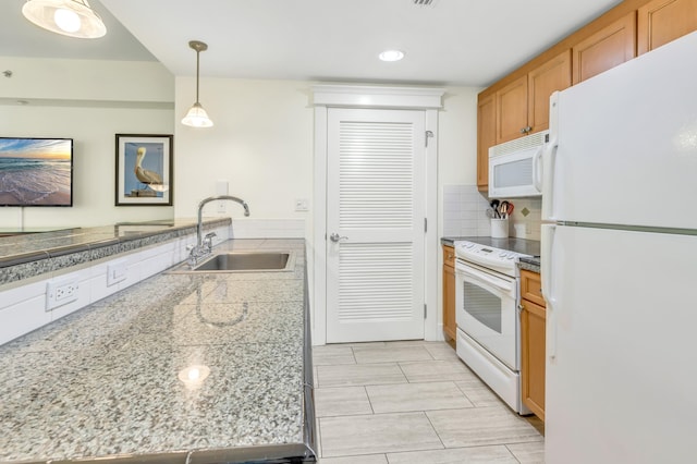 kitchen featuring pendant lighting, white appliances, tasteful backsplash, and sink