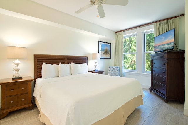 bedroom with light hardwood / wood-style flooring and ceiling fan