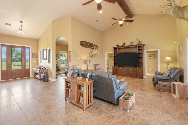 living room with beam ceiling, high vaulted ceiling, light tile patterned floors, and ceiling fan