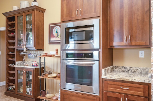 kitchen with light stone counters and stainless steel appliances