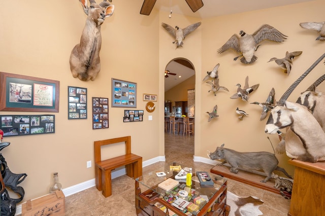 living room featuring ceiling fan and vaulted ceiling