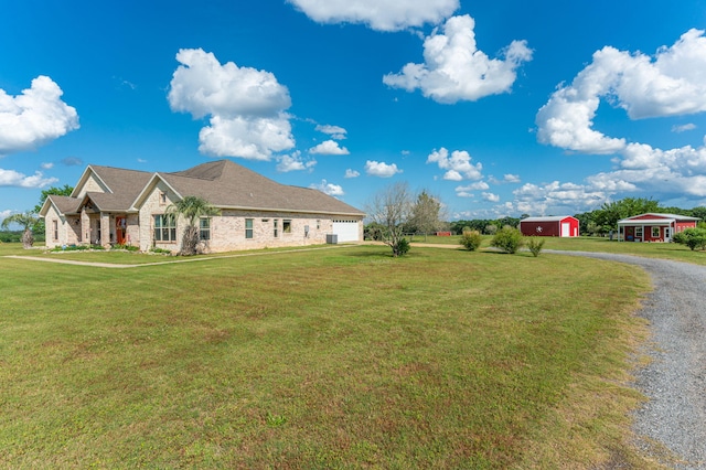 view of front of house with a garage and a front lawn