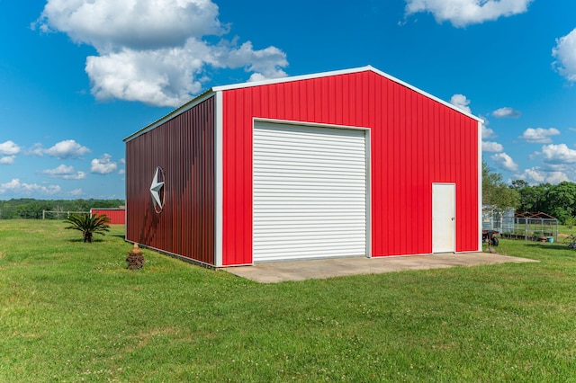 view of outbuilding with a lawn and a garage