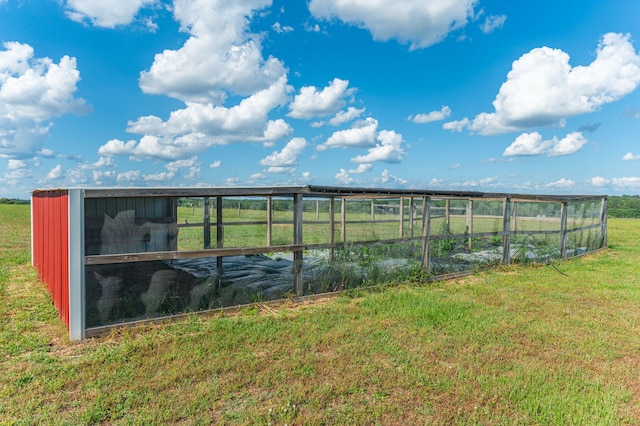 exterior space with an outdoor structure and a rural view