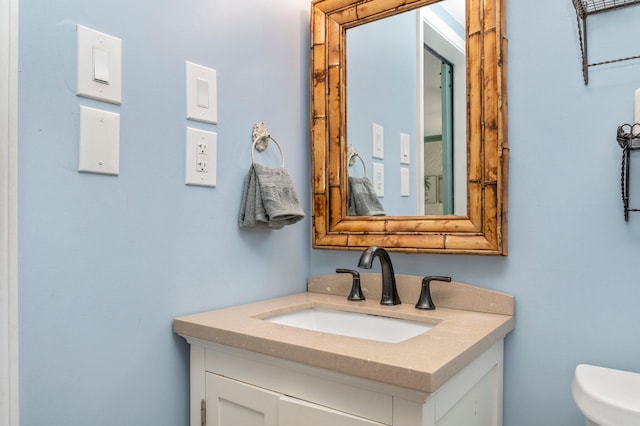 bathroom featuring toilet and vanity