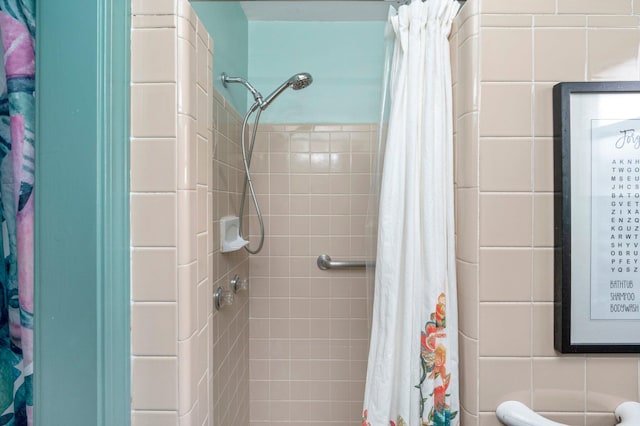 bathroom featuring tile walls and walk in shower