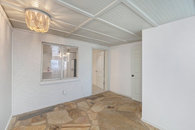 spare room featuring an inviting chandelier