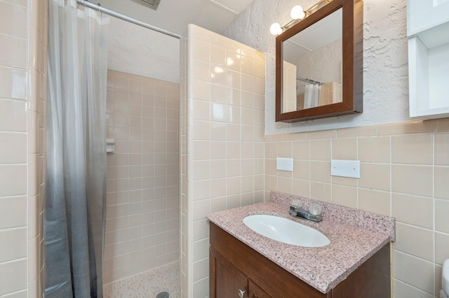 bathroom featuring tile walls, vanity, and backsplash