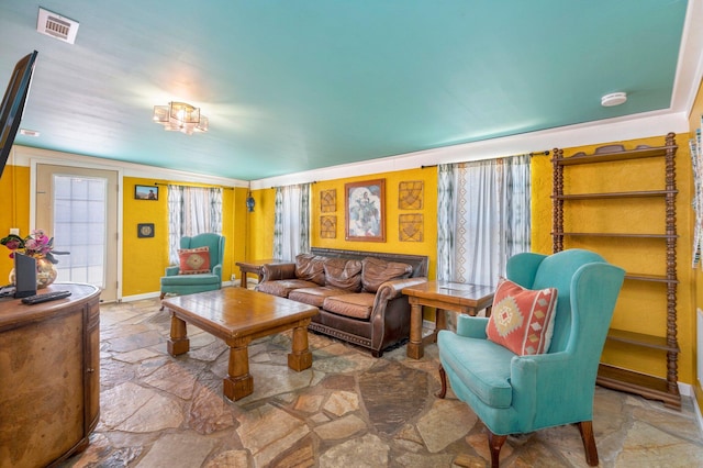 living room featuring ornamental molding and tile flooring