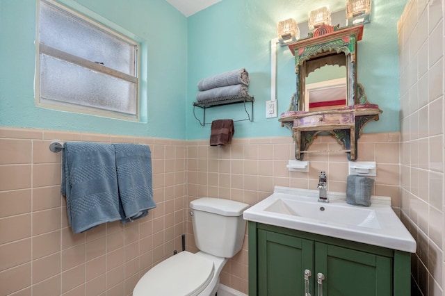 bathroom featuring toilet, oversized vanity, and tile walls