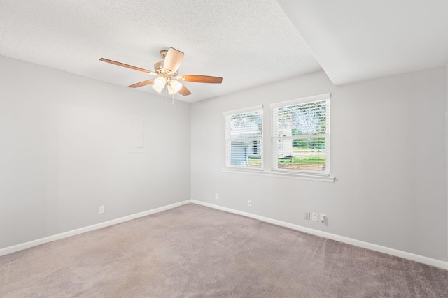 carpeted empty room with a textured ceiling and ceiling fan