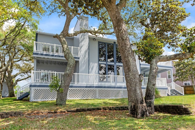 rear view of property featuring a yard