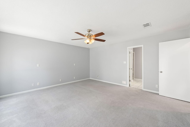 unfurnished room with ceiling fan and light colored carpet