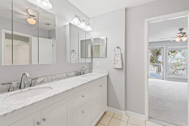 bathroom featuring tile patterned floors, vanity, ceiling fan, and a textured ceiling