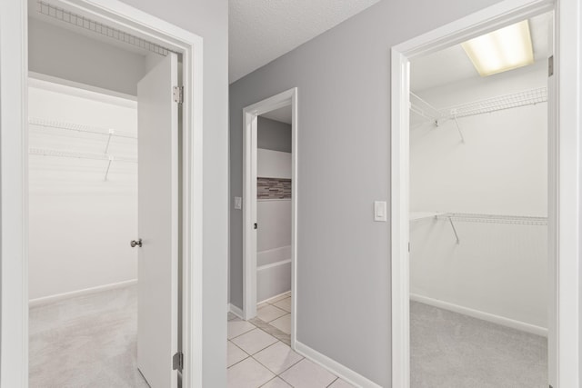 interior space featuring a textured ceiling and tile patterned floors