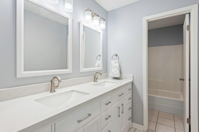 bathroom featuring tile patterned floors, vanity, and  shower combination