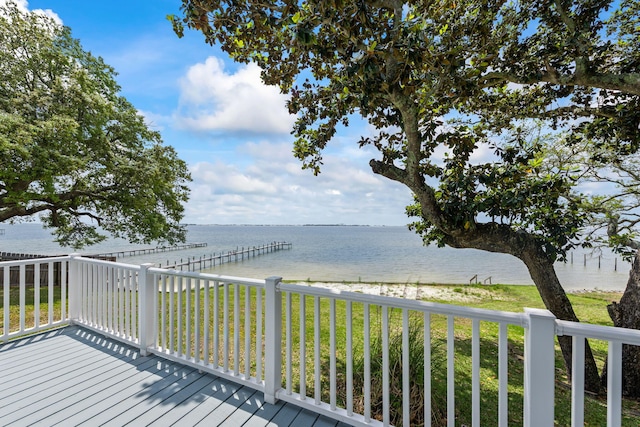 wooden terrace featuring a water view and a dock