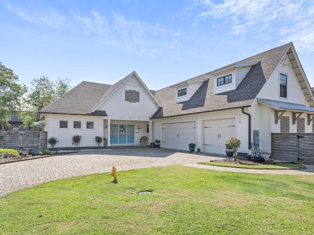 view of front of property featuring a garage and a front yard