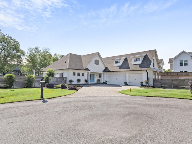 view of front of house with a garage and a front yard